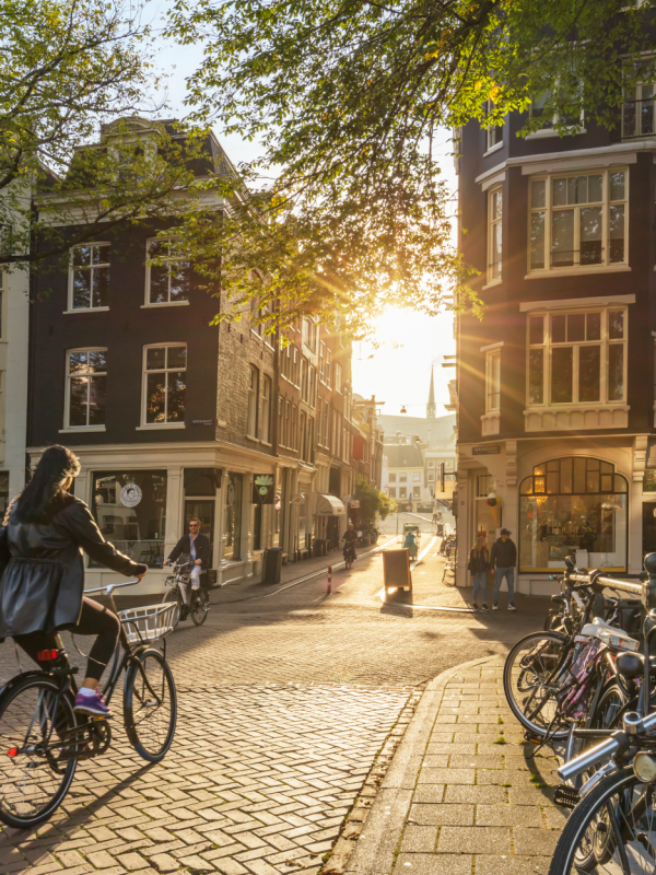 European city view with people walking and riding bicycles