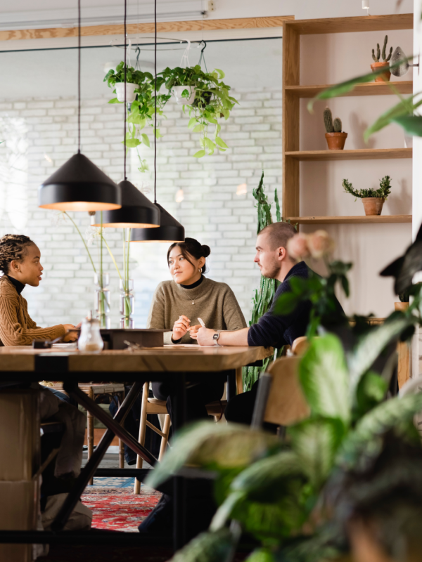 People sitting around a large table having a conversation