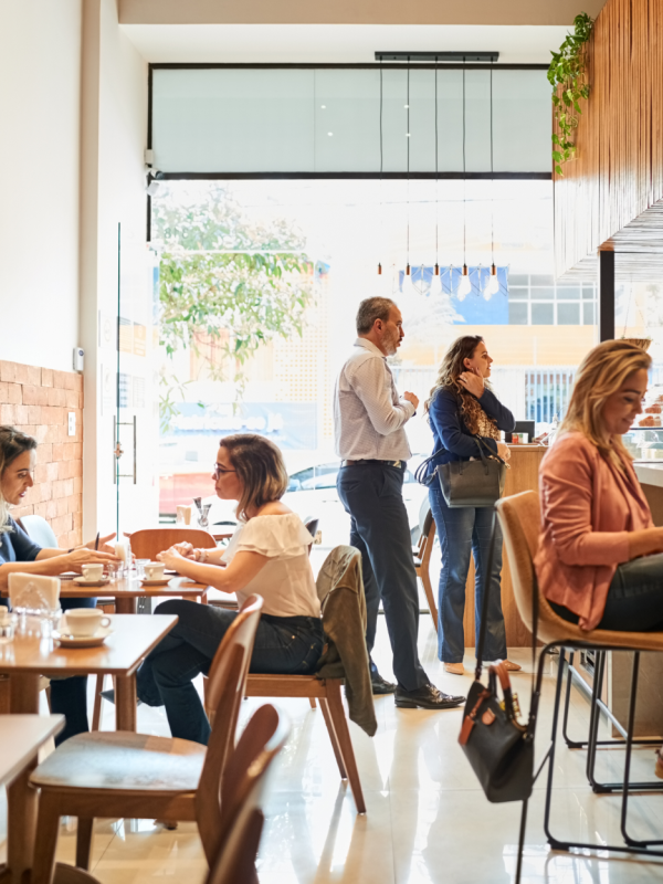 People sitting and standing in a cafe