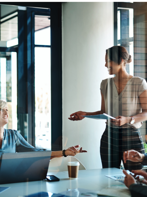 woman speaking to group of peers