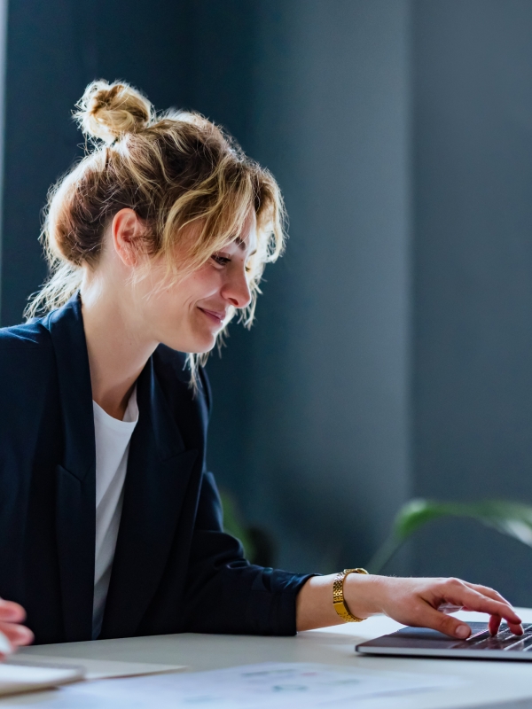Female HR leader remotely facilitating virtual onboarding with a new hire from her laptop