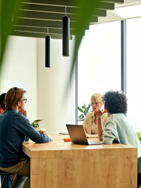 Co-workers discuss a project in a co-working space in Spain