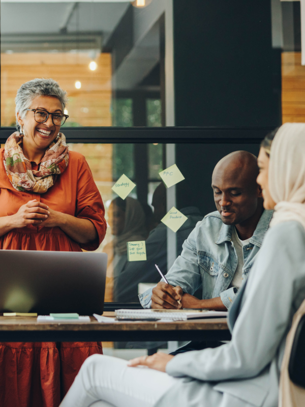 Professionals talking around a table in an office