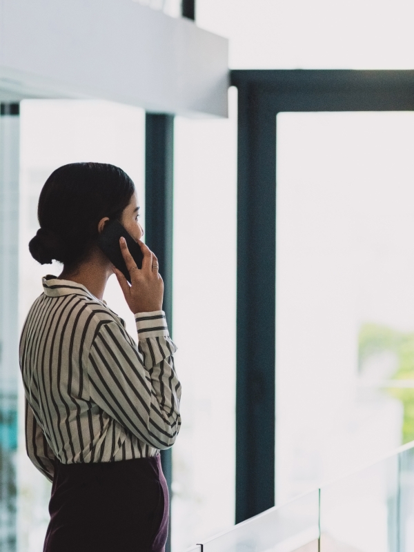 Global HR team member managing global contractors on her phone