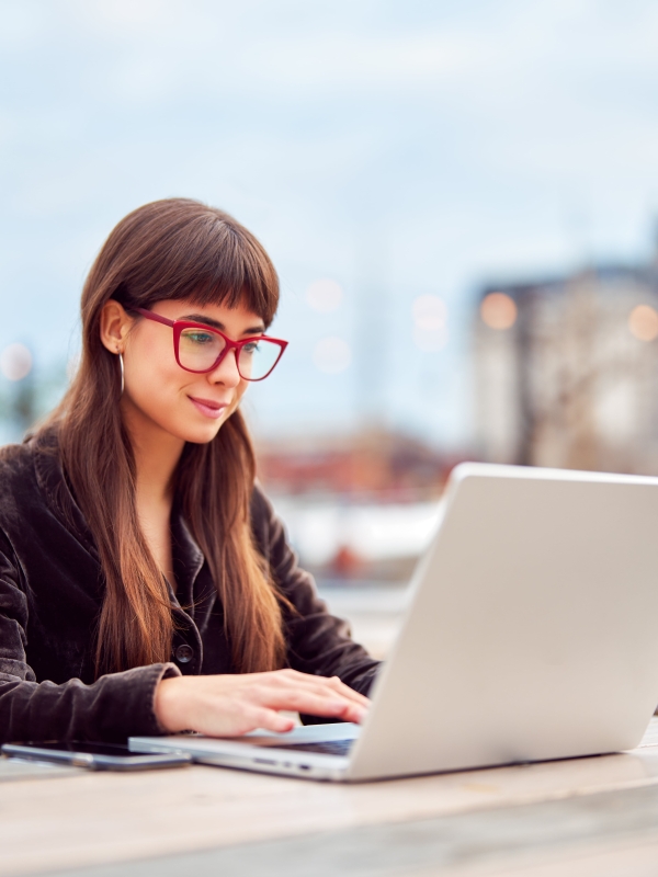 Woman reviewing global HR services on laptop.