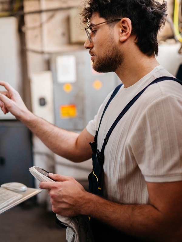 Small business owner checking production quality after using EOR for retail global expansion.