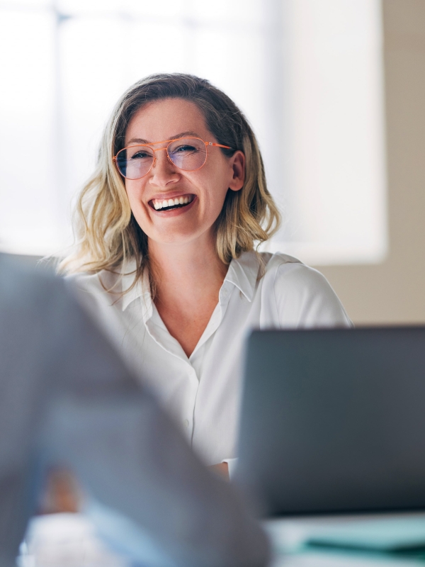Female employer smiling after Pebl (formerly Velocity Global) partnership.
