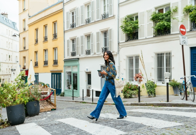 Woman walking through the streets of Paris, France.
