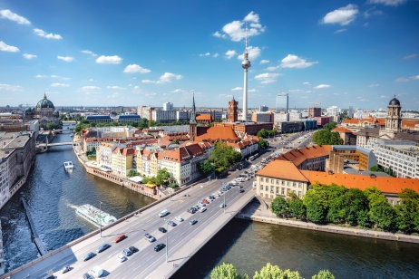 Overhead view of Berlin city skyline with river and Fernsehturm on a sunny day.
