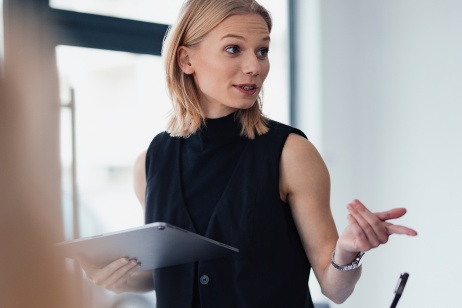 Professional woman in office setting providing HR strategy for hiring freezes.