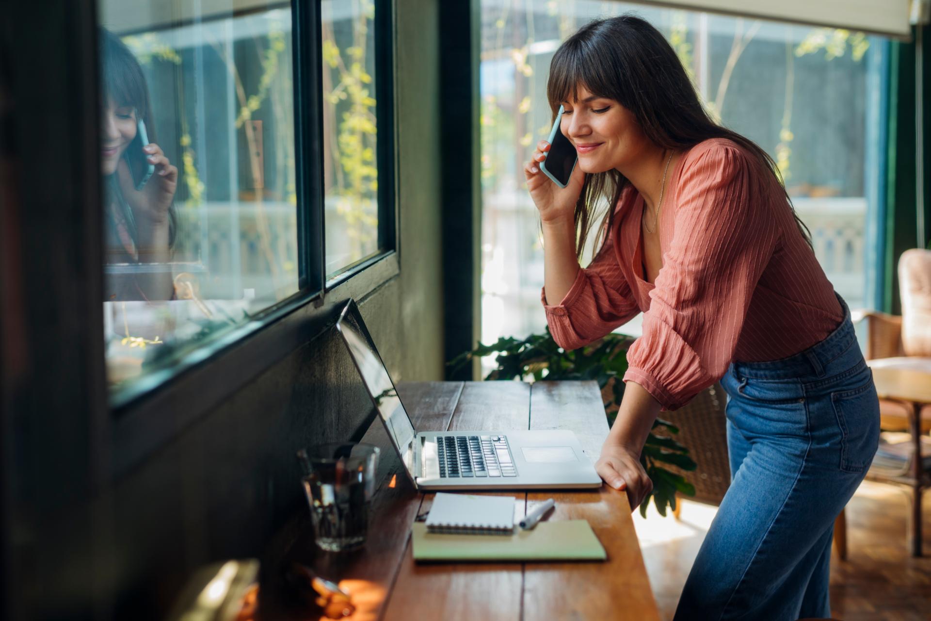 woman talking on phone laptop
