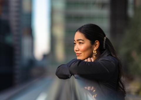 Woman looking out into a business district area