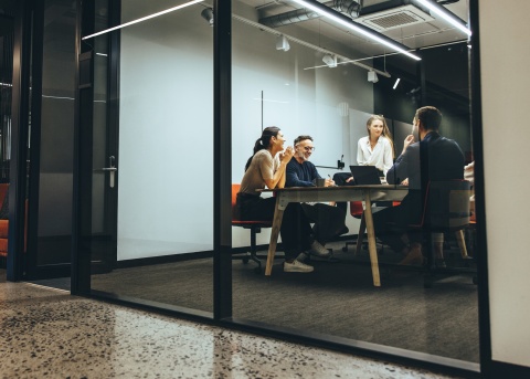 Co-workers enjoying themselves as they meet in conference room.