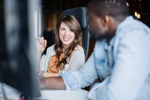 Focus on woman talking with blurred man on how to get a work visa in Angola
