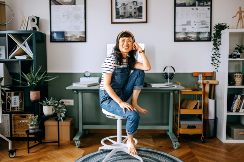 Entrepreneur in her home office thinking about growing her small business