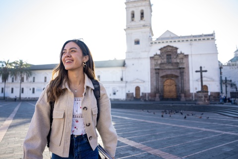 Woman standing in Santo Domingo church plaza in Quito Ecuador