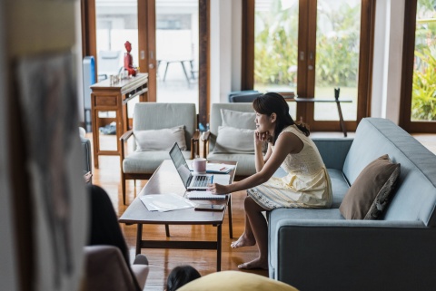 HR manager going through an HR compliance checklist on her laptop