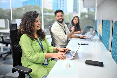 Colleagues discussing Indian work culture at the office