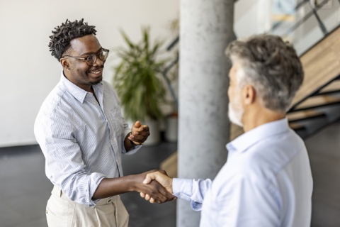 Two businessmen shaking hands in an office in Botswana