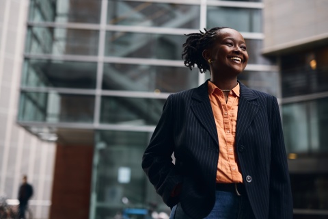 Businesswoman in Costa Rica smiling outside of office building