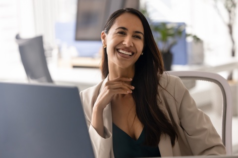 Smiling woman in Burundi with a computer monitor