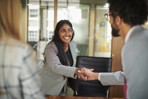 Woman wearing glasses shaking hands after an interview in Belize