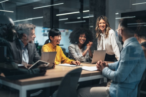 Colleagues discussing SMB growth strategy in modern conference room.