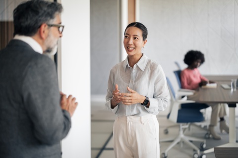 Businesswoman talking with colleague about payroll taxes in Sri Lanka