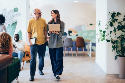 Two professionals discussing work in a modern office in Macedonia