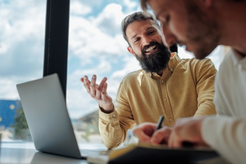 Two businessmen having a meeting about payroll taxes in Pakistan