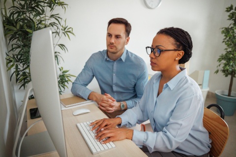 Global HR managers researching payroll tax in Uzbekistan together