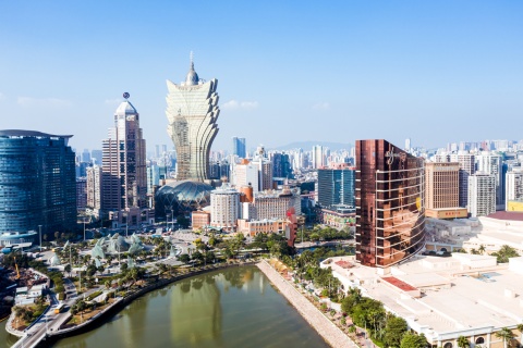 Urban landscape of Macau with the famous traveling tower under a blue sky