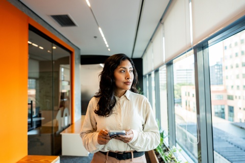 Young woman looking out the window in an office