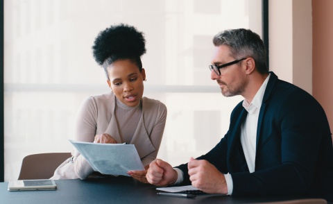 Two business people working on payroll taxes in Indonesia