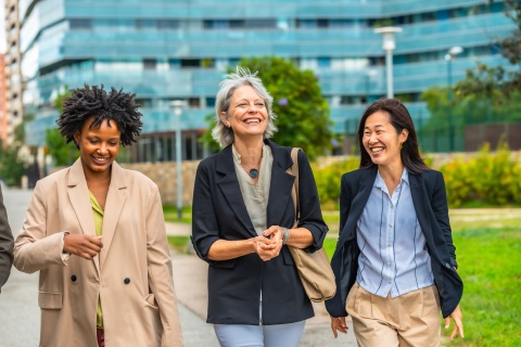 Businesswomen in Finland walking and talking outside in an urban park