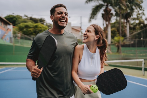 Couple smiling at a pickleball court enjoying Niger’s public holidays