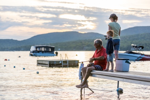 Family fishing at sunset during a summer public holiday in Estonia