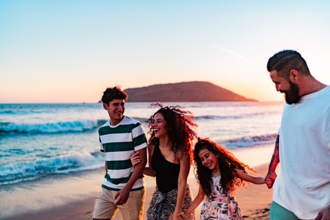 Family walking on a beach, enjoying Trinidad and Tobago’s public holidays