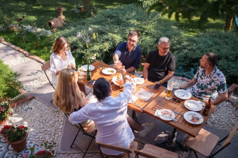 Friends enjoying an outdoor garden dinner together during a public holiday in Eswatini