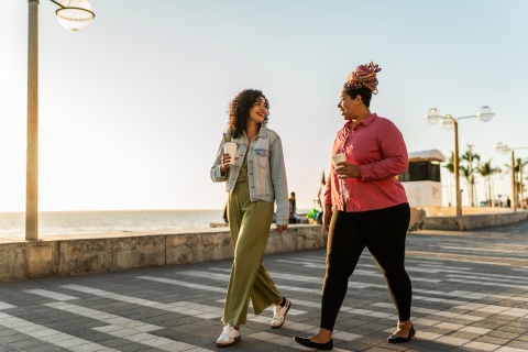 Friends walking along a beach during Angola’s public holidays
