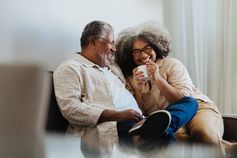Happy senior couple enjoying coffee together at home during a Sierra Leone public holiday