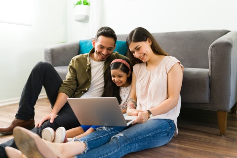 Family watching a movie on a laptop during Mexico’s public holidays
