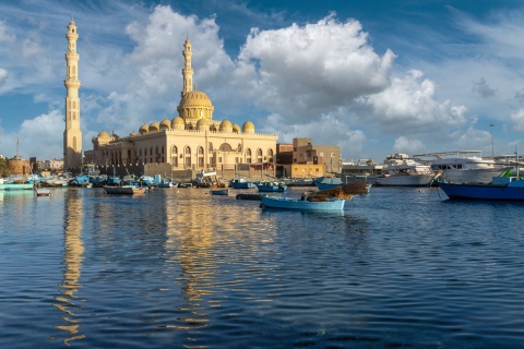 Hurghada mosque reflecting on the Red Sea with fishing boats
