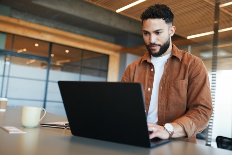 Male research analyst working on his laptop
