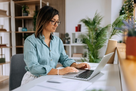 PPC manager working at a laptop in her home office
