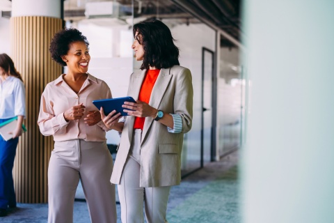 Professional business women discussing workplace culture in Latin America