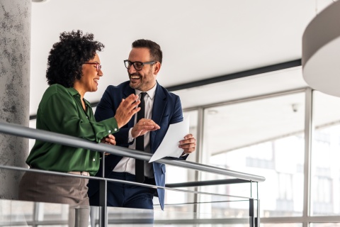 Two professional colleagues sharing ideas in a modern office