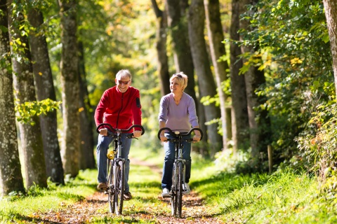 Couple riding bicycles through the forests during Liechtenstein’s public holidays