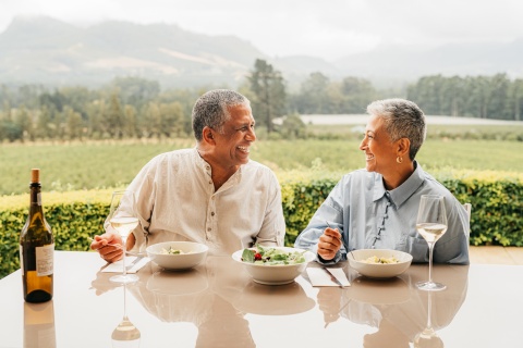 Senior couple eating food at a vineyard on a Kazakhstan public holiday