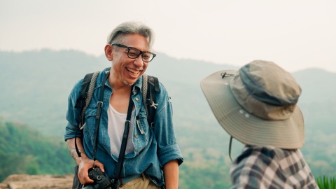 Couple hiking together on a mountain top during Bahrain’s public holidays